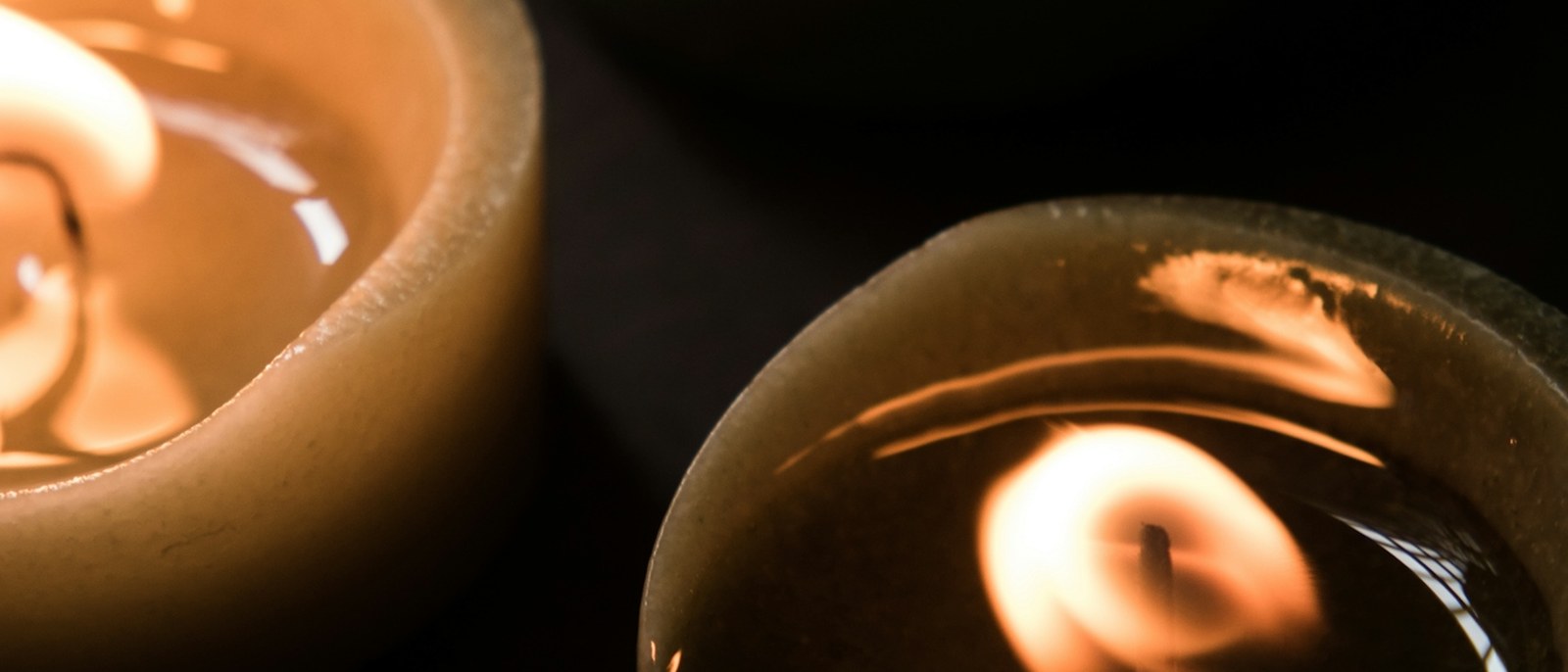 Three candles burning low, close.
